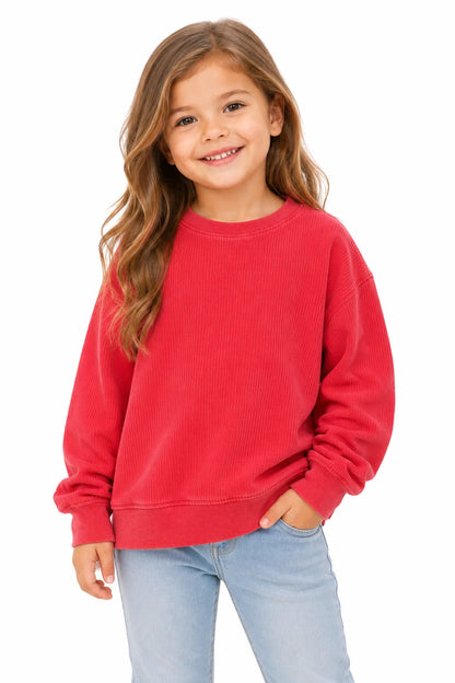 Young girl wearing a red sweatshirt and light blue jeans on a white background