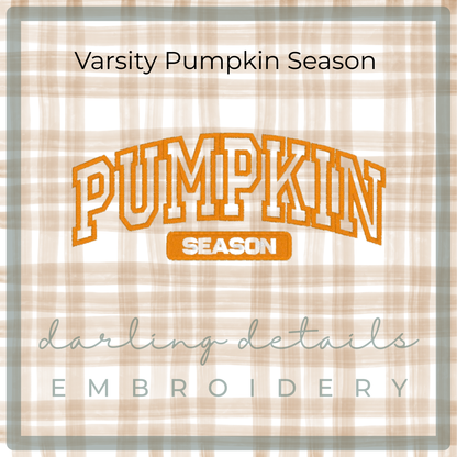 A square embroidery design preview with the words 'Varsity Pumpkin Season' at the top and 'darling details EMBROIDERY' at the bottom. The central design reads 'PUMPKIN SEASON' in orange varsity-style lettering on a beige and white plaid background.